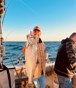 An angler with a big fish in Manistee