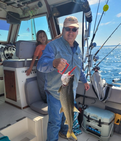 Two people fishing in Manistee, Michigan with a 34-inch fish