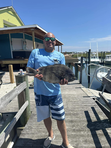Angler holding a 20-inch fish during fishing trip in Cape May