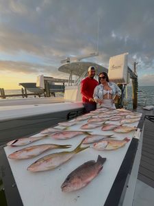 Two anglers fishing in Florida catching 3 fish