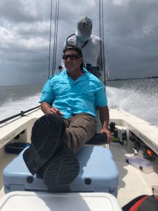 A person fishing in an unknown location