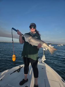 Angler holding redfish caught while fishing in Edgewater FL