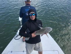 Angler holding a 13-inch fish in Corpus Christi