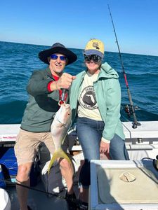 2 anglers holding a 18-inch catch in Marathon