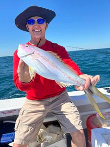 A fisherman holding a 16-inch fish in Marathon