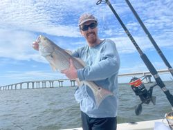 Single fisherman casting a line in Kitty Hawk