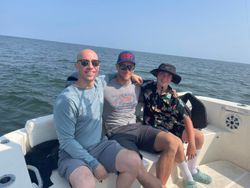 Three people enjoying a fishing trip at Kitty Hawk