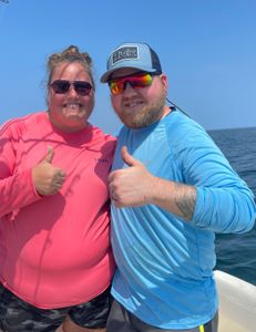 Two people fishing on the shore in Kitty Hawk
