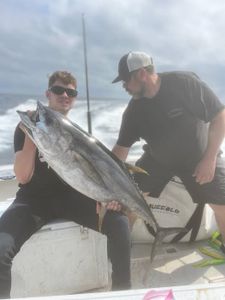 2 people fishing with big fish in MA