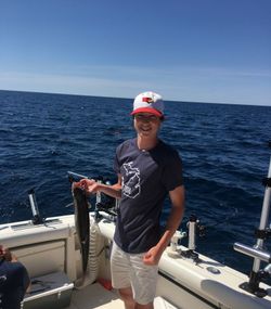 One fisherman holds a 17-inch fish while standing in MI.