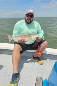 A lone angler fishing on the shores of South Padre Island