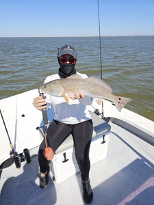 Angler with a large redfish caught while fishing in TX