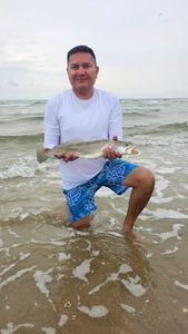 Angler holding a spotted weakfish caught at South Padre Island