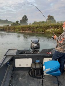 Fishing rod bent with catch on boat in Fruitport MI river