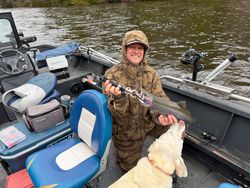 Rainbow trout catch on fishing boat in Fruitport MI with dog companion