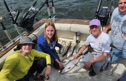 Four people fishing on the water in MI