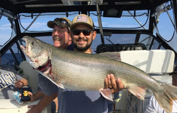 Angler holding a large lake trout in MI