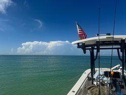 Fishing boat with American flag on turquoise waters near Chesapeake FL
