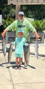 Three large cero mackerel, king mackerel, and great barracuda caught on a fishing trip in Orange Beach