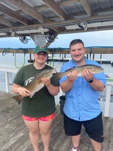 Two redfish caught during fishing trip in Orange Beach