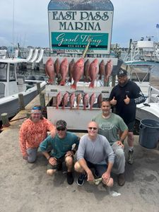Red snapper fishing success at East Pass Marina in Destin Florida with multiple fish displayed
