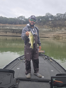 A person fishing for a 13-inch Florida Bass in Texas