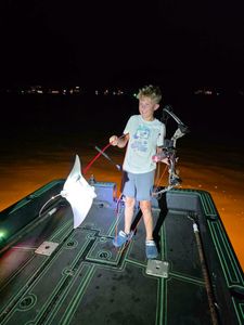 Night fishing setup on boat deck in Orange Beach AL with bow fishing equipment and lights