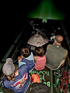 Night fishing scene in Orange Beach AL showing fish cleaning station with fresh catch under green lighting
