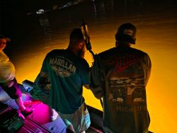 Fishing boat at sunset in Orange Beach Alabama with anglers preparing equipment