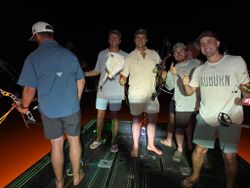 Night fishing trip on boat in Orange Beach AL with bow fishing equipment