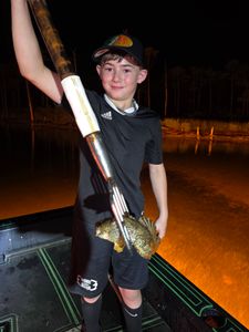 Night fishing trip in Orange Beach AL with freshly caught fish and fishing equipment on boat