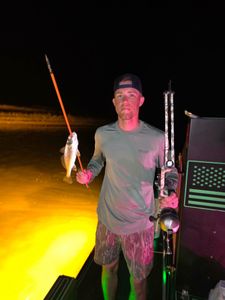 Night fishing catch with spear and bow fishing equipment in Orange Beach AL