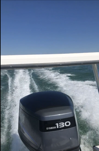 Yamaha 130 outboard motor creating white wake while fishing boat moves through green ocean waters in Islamorada FL