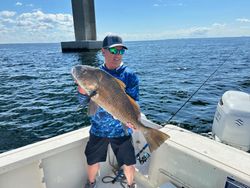 A lone fisherman reeling in a 22-inch catch in FL