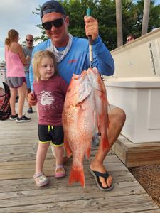 Red snapper catch displayed on wooden dock in Shalimar FL
