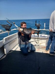 Angler holding a 26-inch fish while fishing in NY
