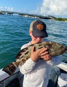 Little Angler Was Mesmerized By The Grouper 