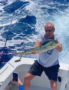 A lone fisherman in Marathon, Florida catching a 24-inch fish during a fishing trip.