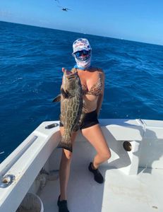 A fisherman holds a 25-inch fish in Marathon, Florida.