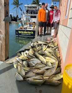 Five people enjoying a fishing trip in Marathon