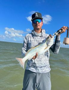 A single fishing enthusiast with a big 23-inch catch in Matagorda