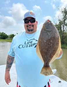 Angler with a large Southern Flounder in Matagorda