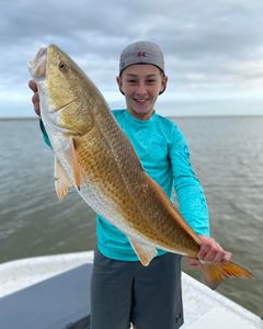Angler holding a 24-inch fish in Matagorda
