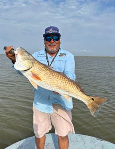 Angler holding a 28-inch fish in Matagorda