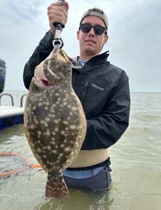 Angler holding a Southern Flounder caught in Matagorda, Texas
