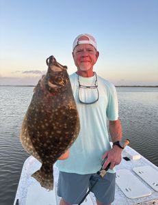 Photograph of a southern flounder, a 27-inch fish caught while fishing in Matagorda