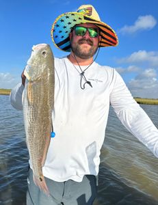 A fisherman with a 25-inch catch in Matagorda