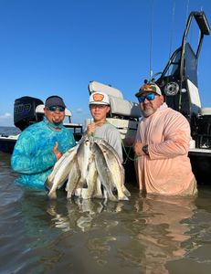 Two fishermen with a catch of fish in Matagorda, Texas