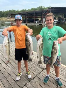 Two anglers with four striped bass in Kingston