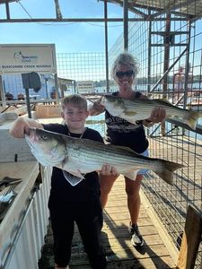 Two anglers fishing for striped bass in Kingston